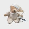 Noukies Cutie μουσικό λούτρινο αρκουδάκι 25cm, απαλό μπεζ χρώμα, με πιτζάμα και λευκό δαχτυλίδι έλξης για την ενεργοποίηση της μελωδίας.